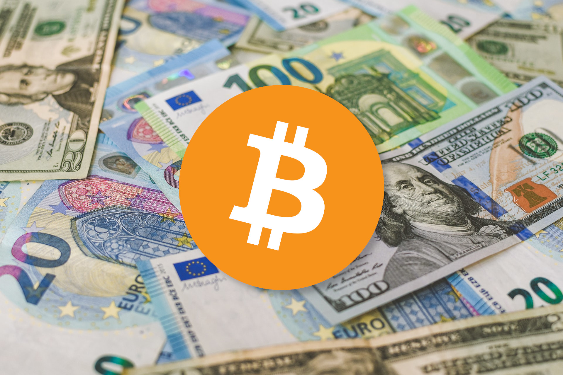 Bitcoin logo in front of USD and EUR