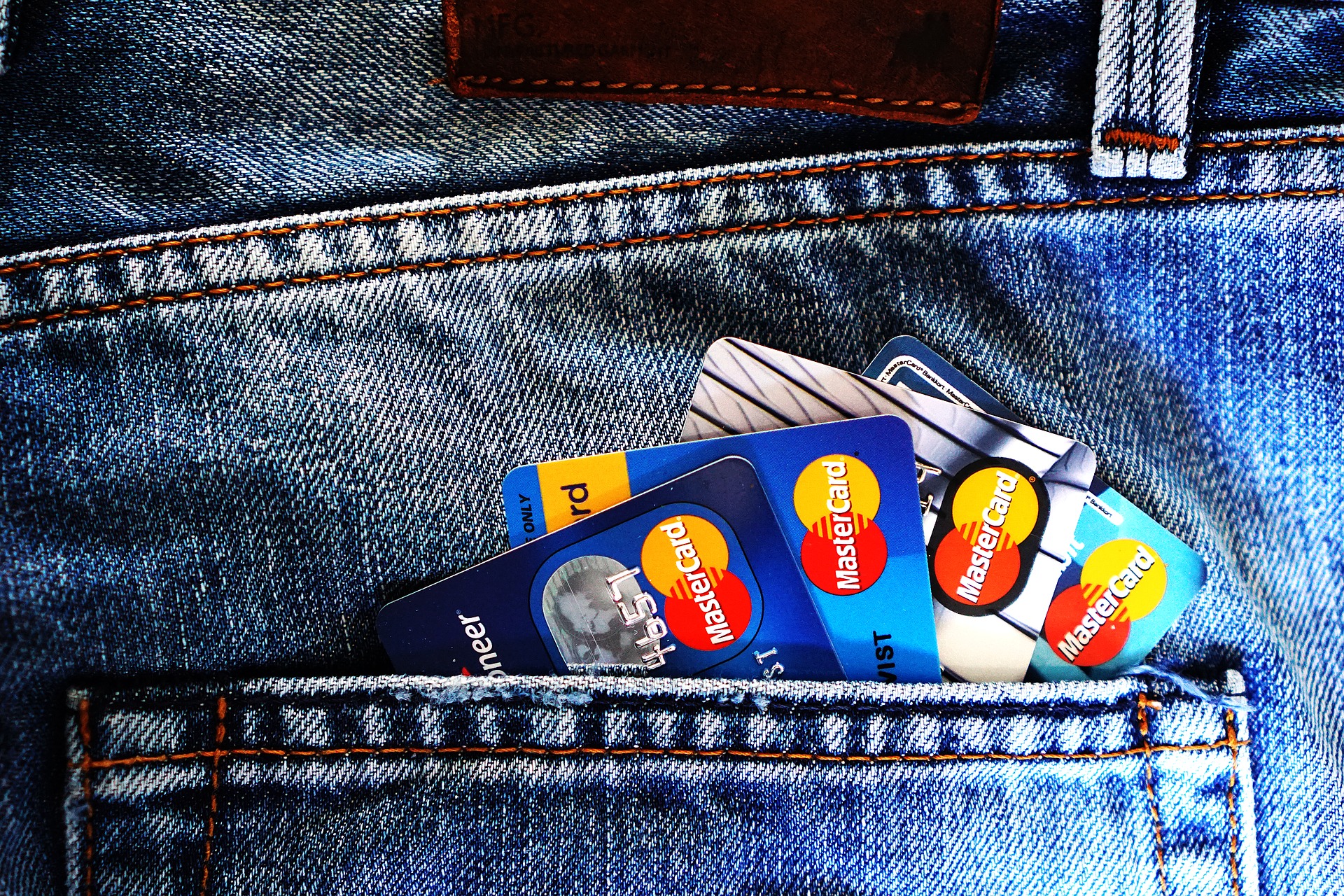 A number of Mastercard cards in a back pocket image cover